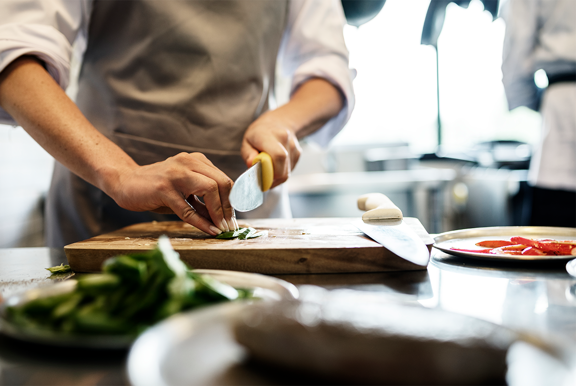 Stanford's steakhouse chef cutting green onions on cutting board