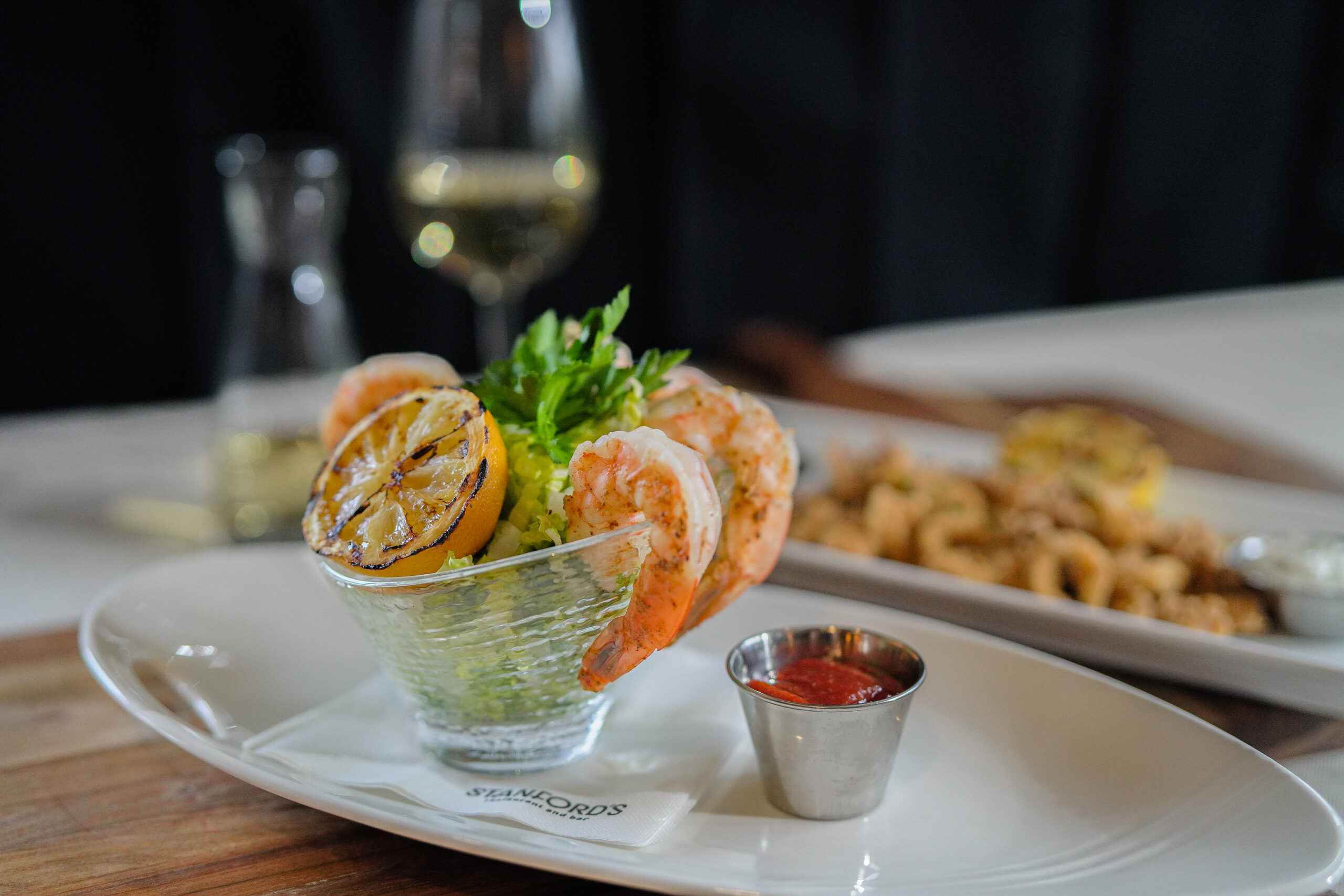 shrimp appetizer in cup with large cooked shrimp